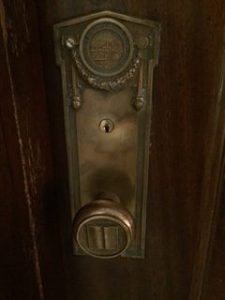 photo of brass doorknob with book detail